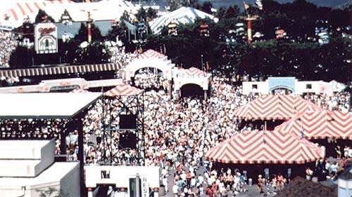 photo of the outdoor Summerfest Music Festival showing patrons walking among large tents