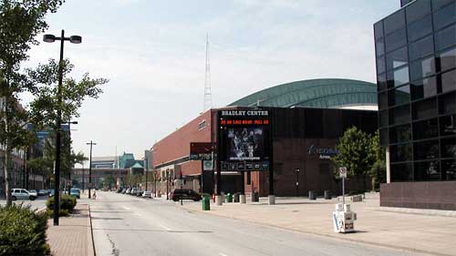 photo of a large convention center on an urban street with a sign on the front stating "Bradley Center"