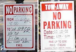 photo showing two temporary no parking signs, each indicating a tow away zone