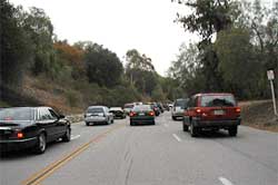 photo showing traffic traversing a three-lane roadway in one direction