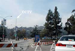 photo showing barricades placed at a four-leg intersection permitting two movements only across the intersection. A closed-circuit television camera is mounted on a light post adjacent to the intersection