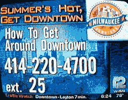 television screen shot advertising telephone number for travel information in downtown Milwaukee: Summer's Hot, Get Downtown, How to Get Around Downtown, 414-220-4700, ext. 25