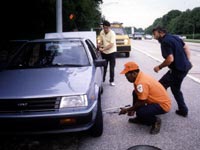 photo of people fixing a flat tire on a roadway