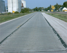 photo of roadway with raised horizontal rumble strips across the lane