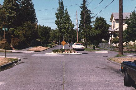 photo of car traveling around traffic circle