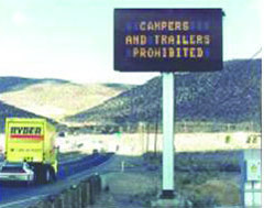 Photograph of highway sign warning travelers that campers and trailers are prohibited