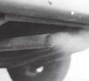 Photograph - Close up of a vehicle's exhaust pipe.  Fumes are being emitted from the exhaust pipe.
