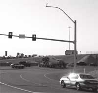 Photograph - Metered Two-lane loop ramp with a car traveling past the ramp meter.