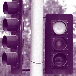 Two traffic signals at an unnamed intersection.