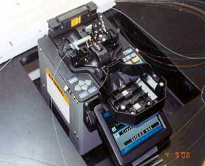 photograph of multiple fibers entering a machine and exiting as a single strand