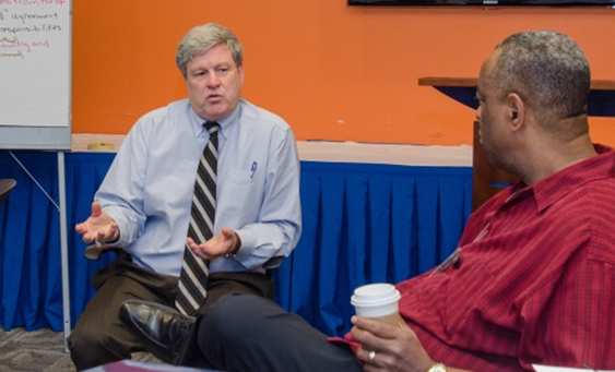 Photograph of Paul Jodoin and John Batiste during a discussion