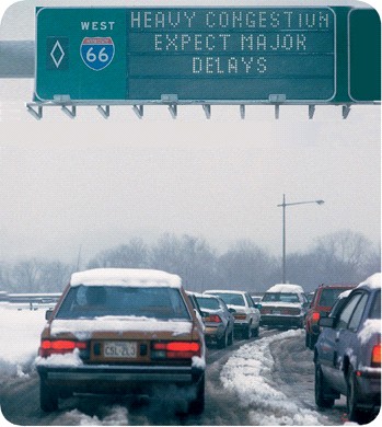 Photograph of traffic congestion during a snow event where heavy snow has accumulated on an Interstate highway