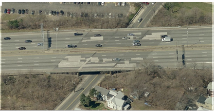 Aerial photo of bridge prior to replacement; decking features many patches.