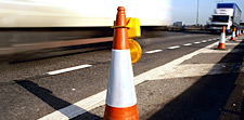 orange cone marks highway work zone