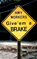 traffic sign reading "Highway Workers - Give 'em a Brake"