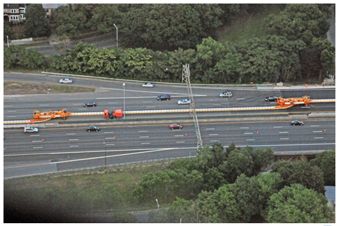 Aerial photo of the barrier being moved using zipper trucks.