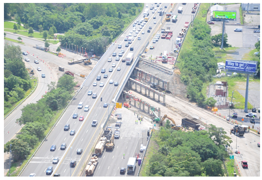 Aerial photo of the overpass after the bridge decking was removed on the southbound lanes, exposing the support pylons and the closed road below.