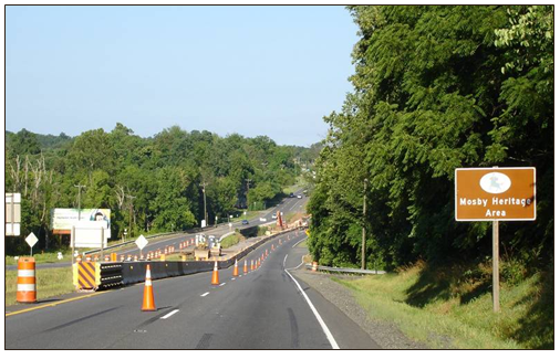 Approach to the work zone area. Cones and other work zone devices are set up in the area upstream and downstream of the bridge.