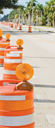 Series of traffic barrels delineating a work zone.