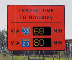 Dynamic message sign shows travel times to reach one destination for two separate routes.