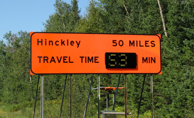 Dynamic sign indicates travel time to next significant destination through work zone.