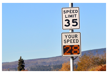 A speed limit sign with a "your speed" indicator below.