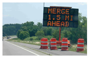 A dynamic message sign indicating a merge 1.5 miles ahead.