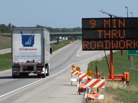 A dynamic message sign indicating the estimated time to travel through the work zone.