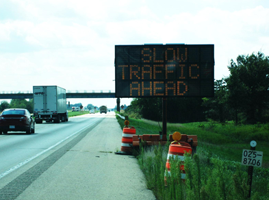 Image shows a dynamic message sign displaying 'Slow Traffic Ahead'.