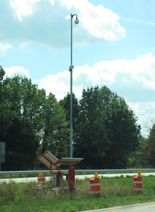 Pole–mounted work zone ITS equipment powered by a small solar panel.