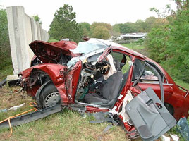 Photo of a crashed car with the driver's door torn off.