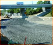 Picture shows a section of the I-670 with roadway surface removed and base material exposed.