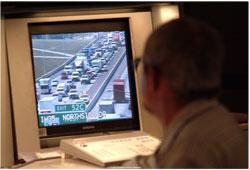 A photograph shows a video terminal with a view of traffic on a multilane road.