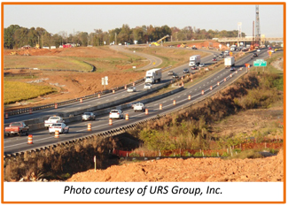 A picture shows traffic moving in both directions on a four-lane highway that has orange barrels set up along the outside lanes. A construction area is shown in the background.  Caption: Photo courtesy of URS Group, Inc.