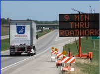Dynamic message sign advises traffic that the travel time through the work zone is 9 minutes.