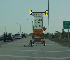 Photo of a portable speed limit sign that warns traffic that a slower speed limit is in effect when the unit's lights are flashing.