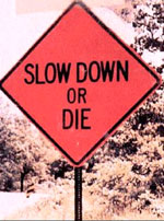 photo of roadway warning sign stating "slow down or die"